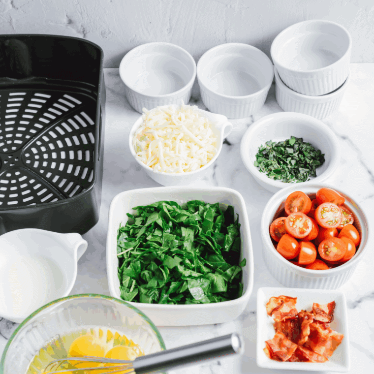 Ingredients needed for Easy Air Fryer Spinach and Tomato Frittata on kitchen table.