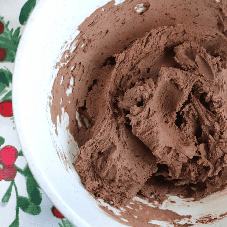 Mixing Nutella, eggs, and flour in a large bowl to make cookie dough.
