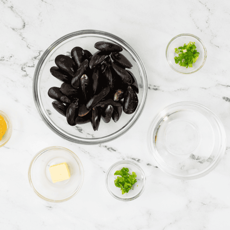Ingredients needed for Air Fryer Classic French Mussels on kitchen table.