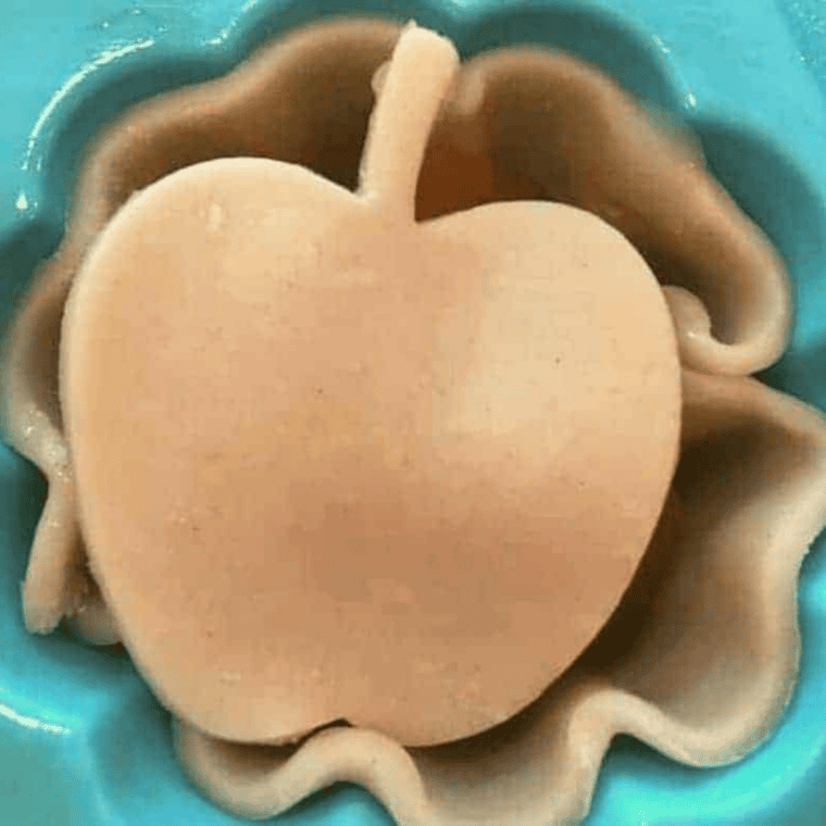 Pie crust tops placed over apple filling before air frying