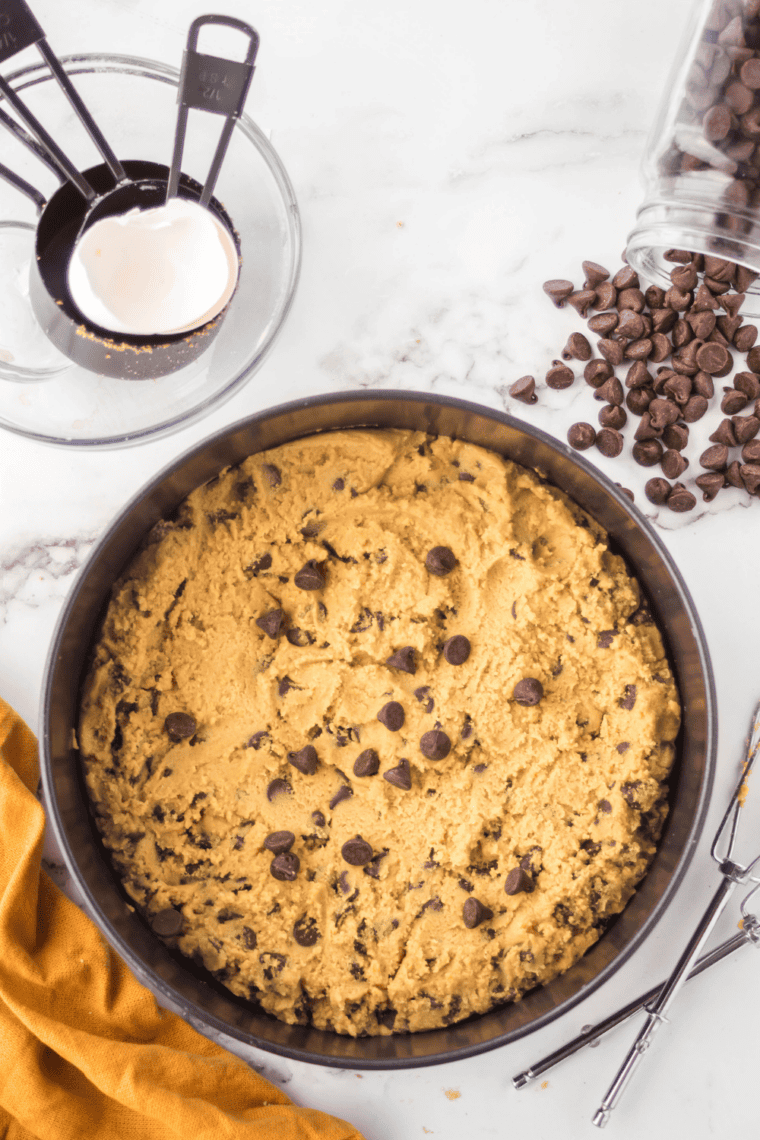 Air fryer pan baking cookie bars at 350&deg;F, checking doneness with a toothpick.