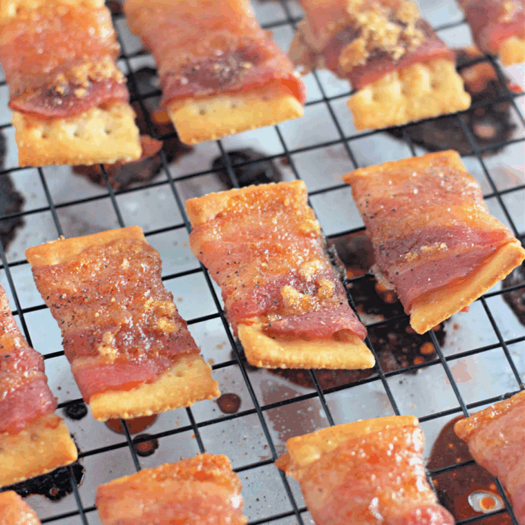 Encase each cheese-covered cracker in bacon, arrange in the air fryer, and cook at 400°F for 8-12 minutes.
