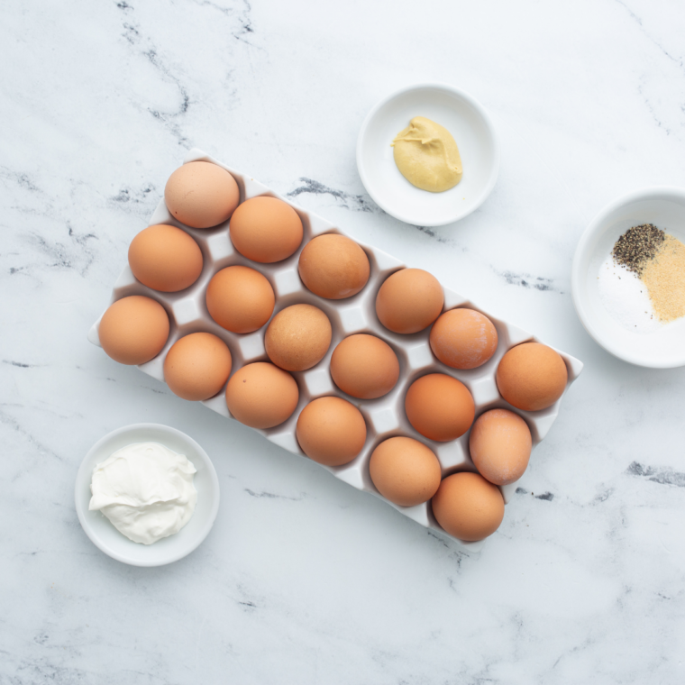 Ingredients needed for Air Fryer Bacon and Egg Crescent Squares on kitchen table.