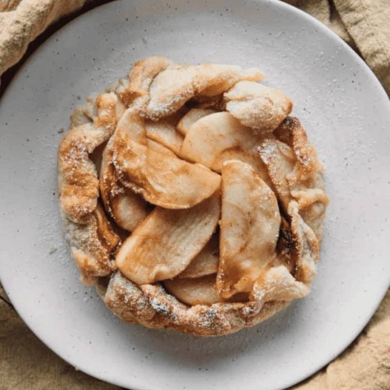 Sliced air fryer rustic apple pie galette served warm on a plate