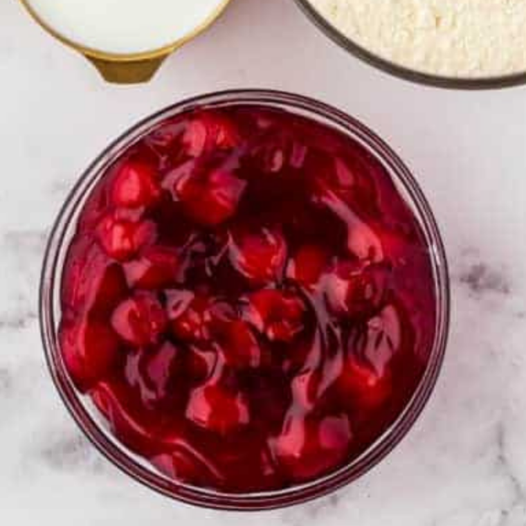 Ingredients needed for Air Fryer Cherry Crescent Rolls on kitchen table.
