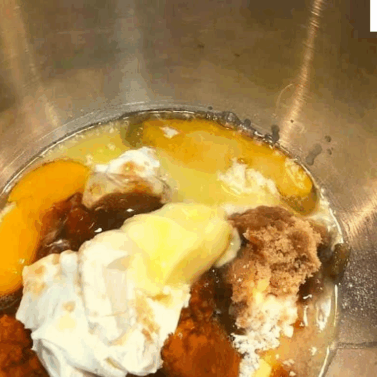 Mixing bowl with dry ingredients—flour, cornmeal, spices—combined with sour cream, pumpkin puree, brown sugar, and melted butter.