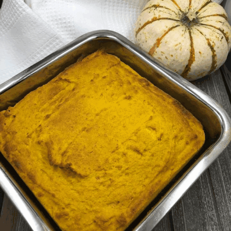 Slice of Easy Air Fryer Pumpkin Cornbread, golden brown with a soft, fluffy interior and autumn spices.