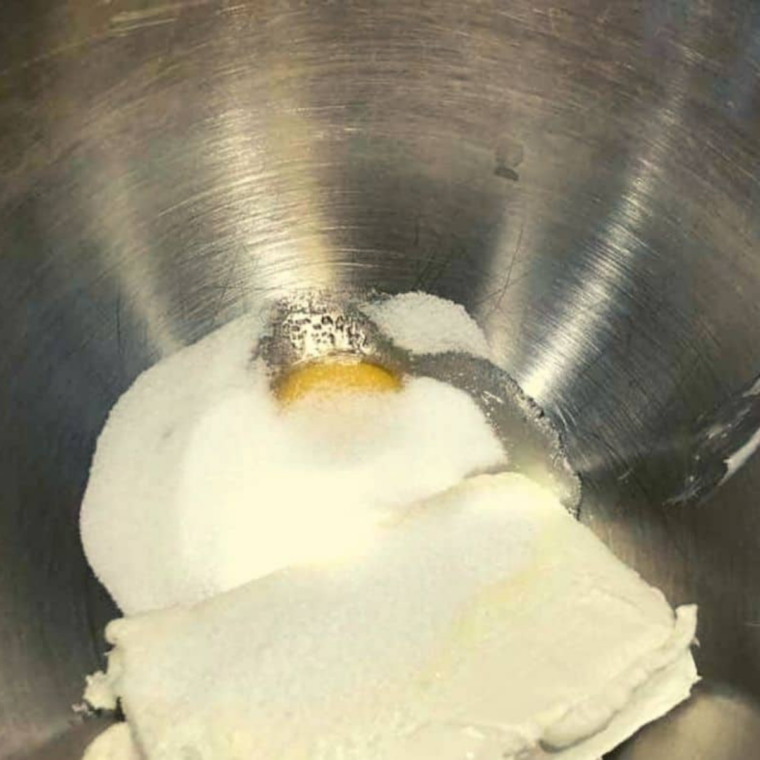 Mixing cream cheese, egg, and sugar in a bowl for creamy crescent roll filling.