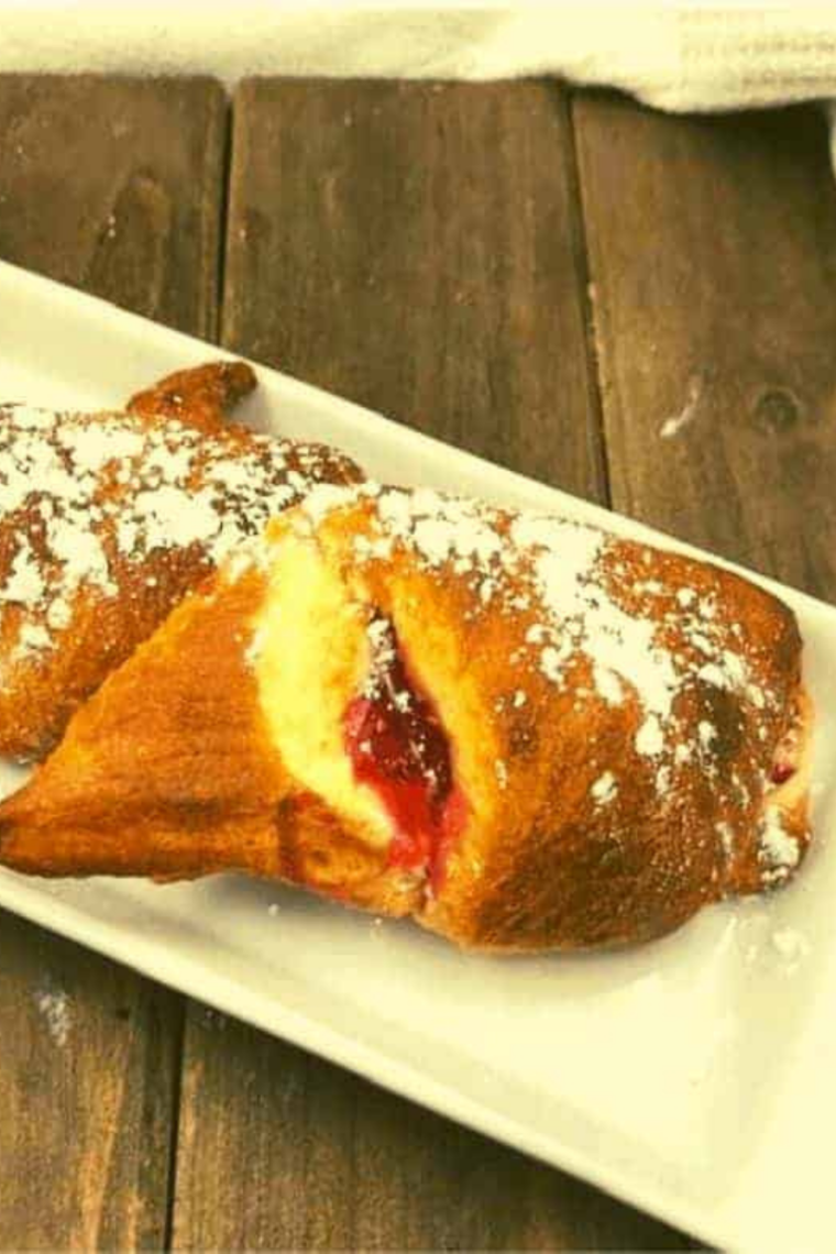 Golden, flaky crescent rolls filled with cream cheese and cherry pie, fresh from the air fryer.