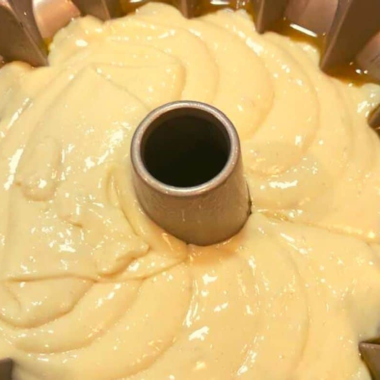 Lemon cake batter poured into a greased bundt pan