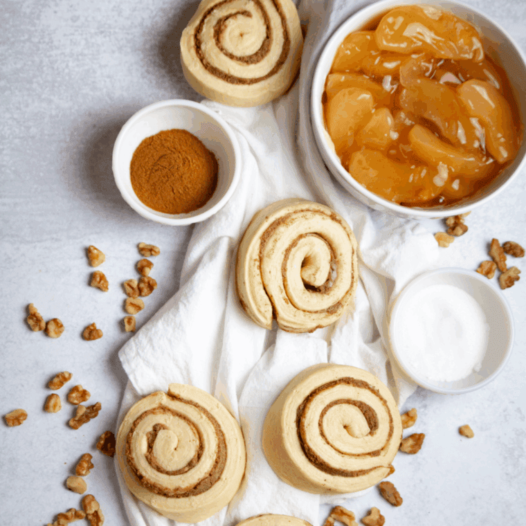Ingredients needed for Air Fryer Cinnamon Roll Apple Pie on kitchen table.