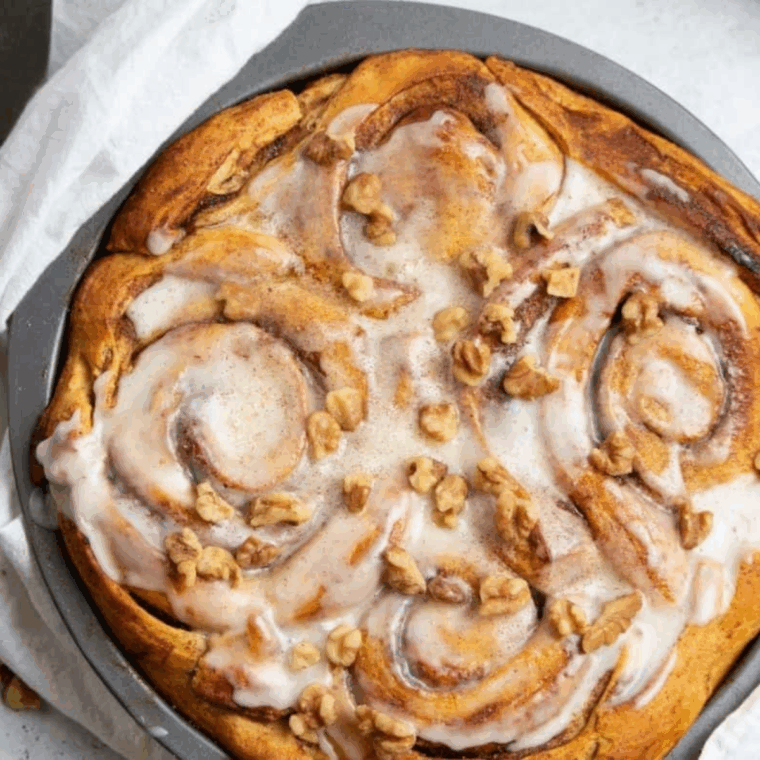 Cinnamon roll apple pie with a lattice cinnamon roll crust and icing drizzle