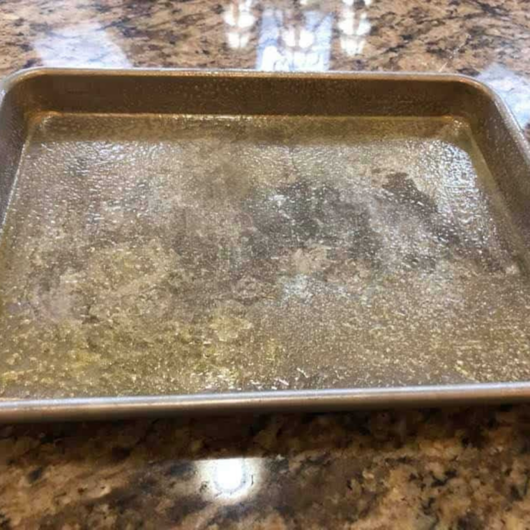 Pizza dough stretched into a quarter sheet pan brushed with olive oil