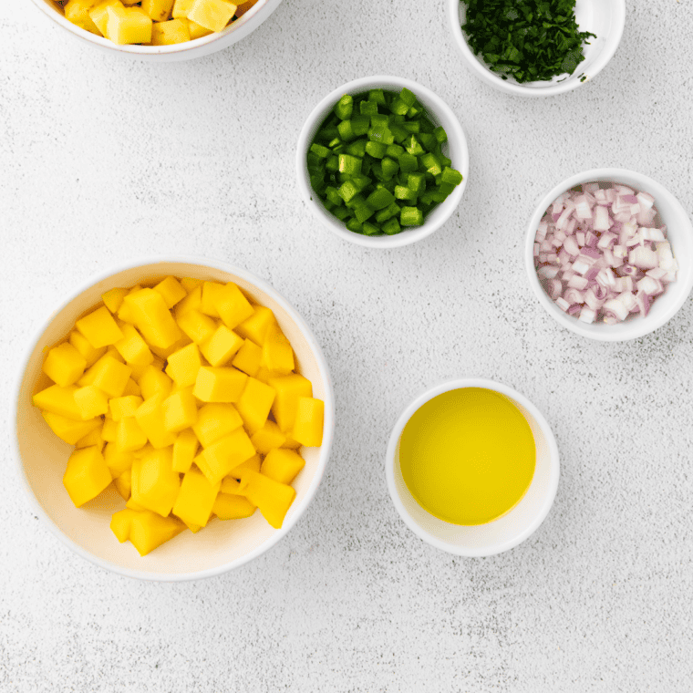 Ingredients needed for Air Fryer Swordfish With Mango Salsa on kitchen table.