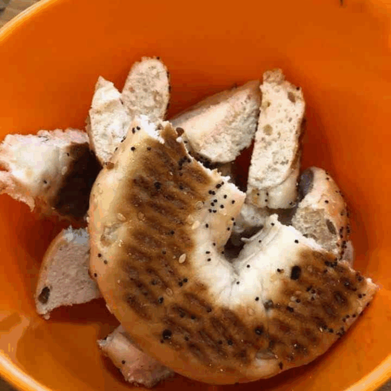 Add bagels, seasonings and olive oil to a large mixing bowl, mix well to coat.