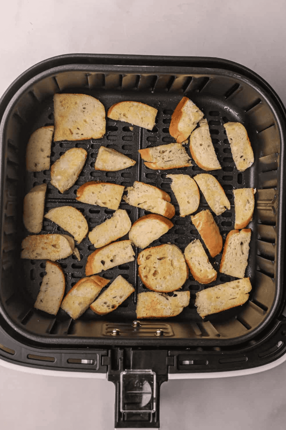 Place seasoned Everything Bagel Chips in the air fryer basket.