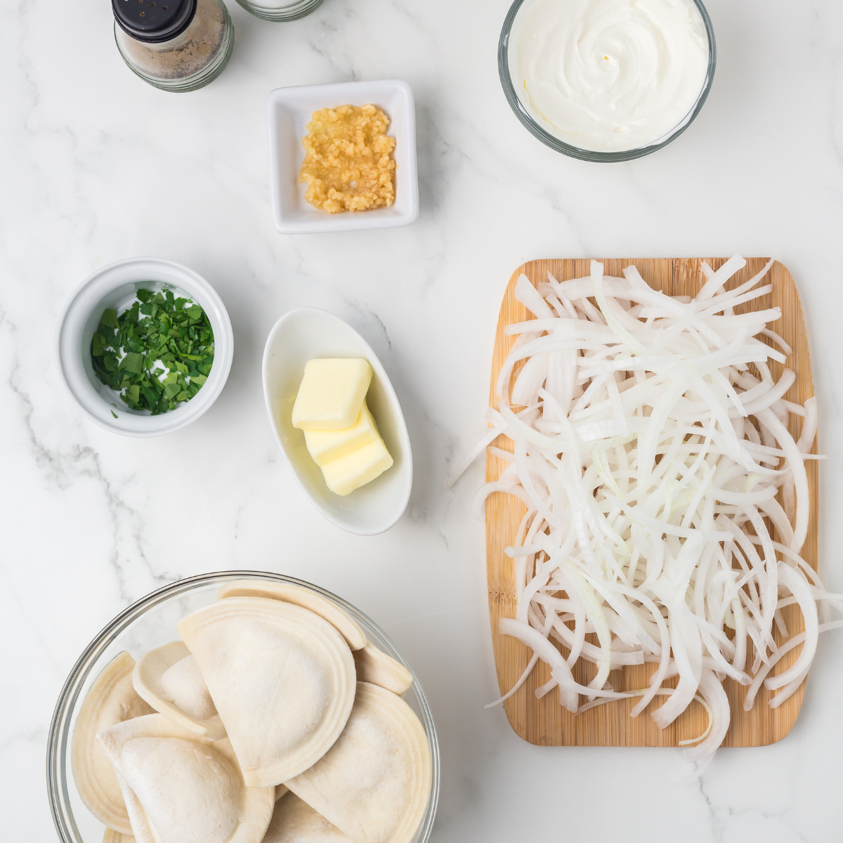 Ingredients needed for Easy Air Fryer Pierogies And Onions on kitchen table.
