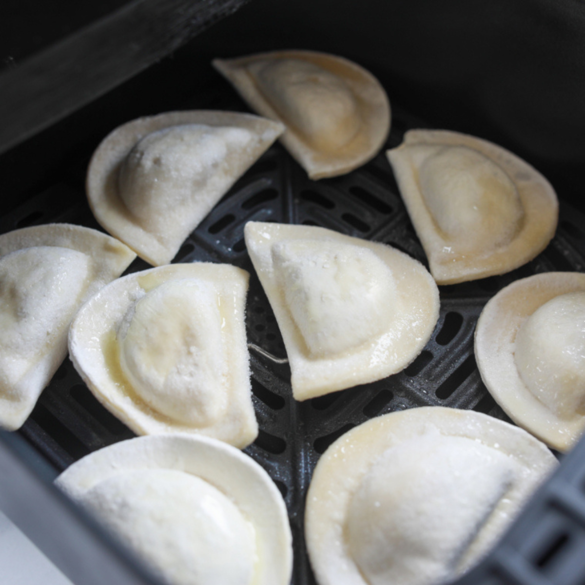 closeup: frozen pierogies in the air fryer basket