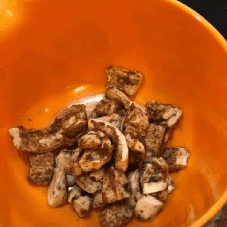 Refrigerated cinnamon rolls cut into half-inch pieces in a white mixing bowl