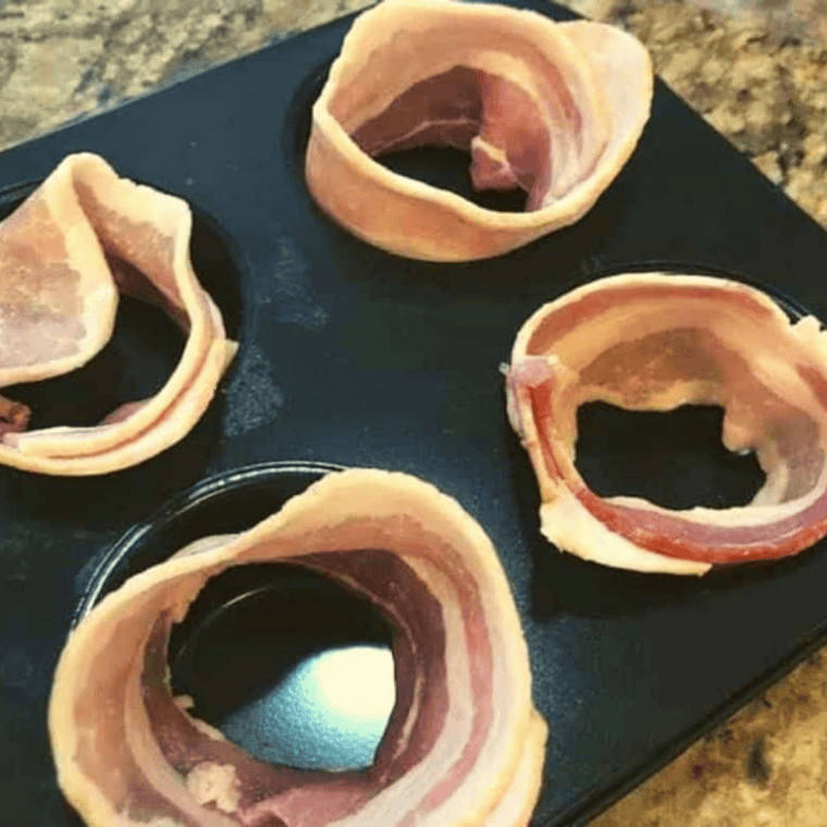 Bacon slices lined inside muffin tin cups to form little baskets for Air Fryer Bacon and Egg Cups
