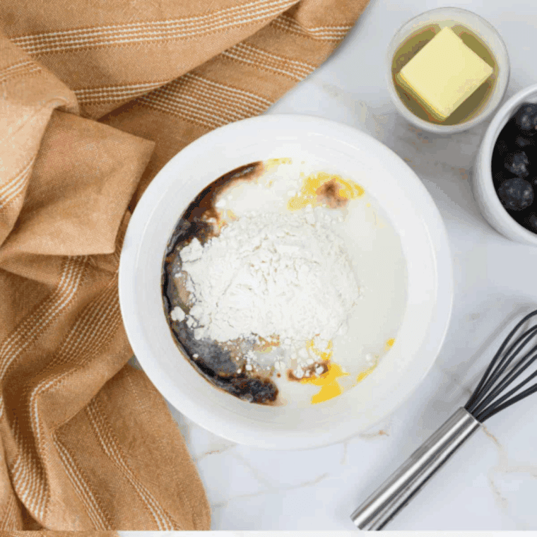 Blending flour, eggs, and milk in a blender until smooth