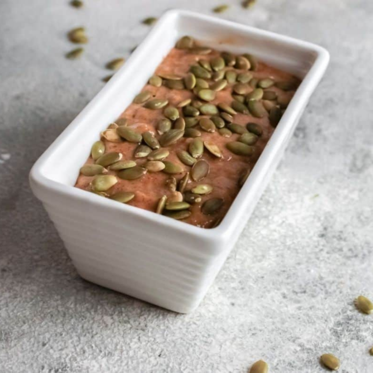 Pumpkin bread batter poured into a greased mini loaf pan