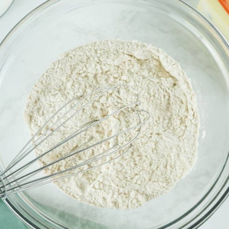 Gluten-free flour, baking soda, and salt whisked together in a bowl
