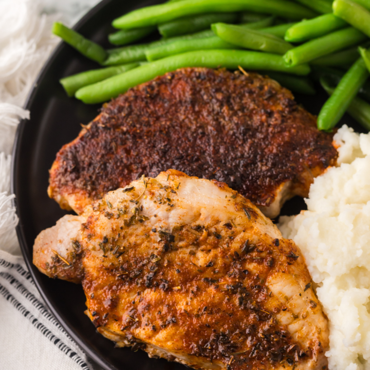 Air fryer honey garlic pork chops glazed and garnished, ready to serve
