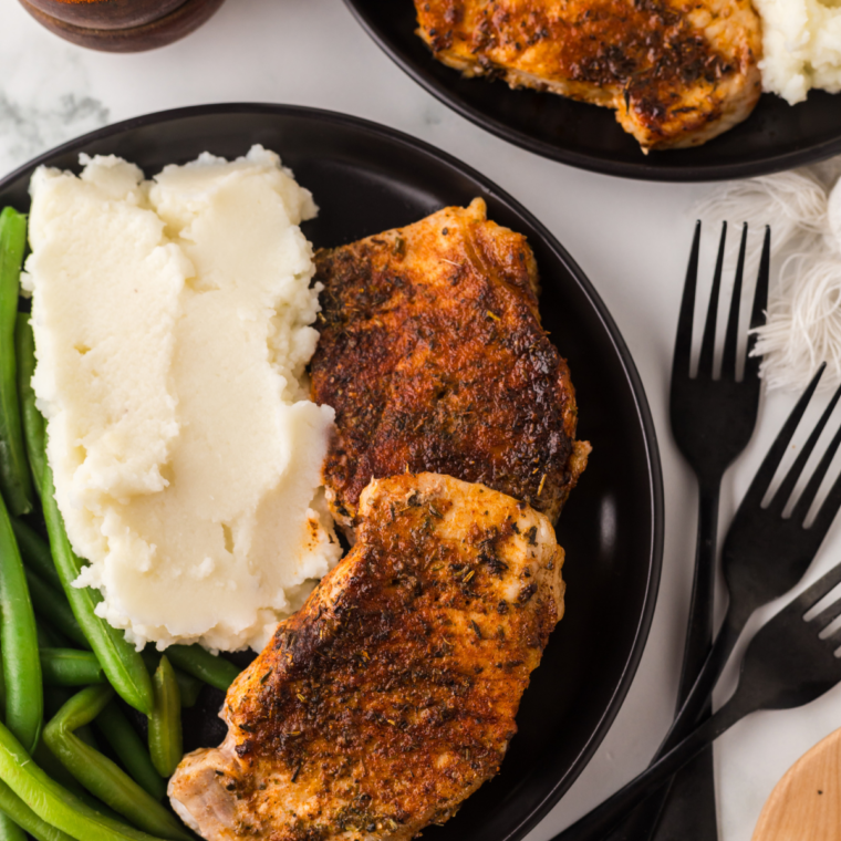 Air fryer honey garlic pork chops in a sticky honey glaze — a 24-minute weeknight dinner