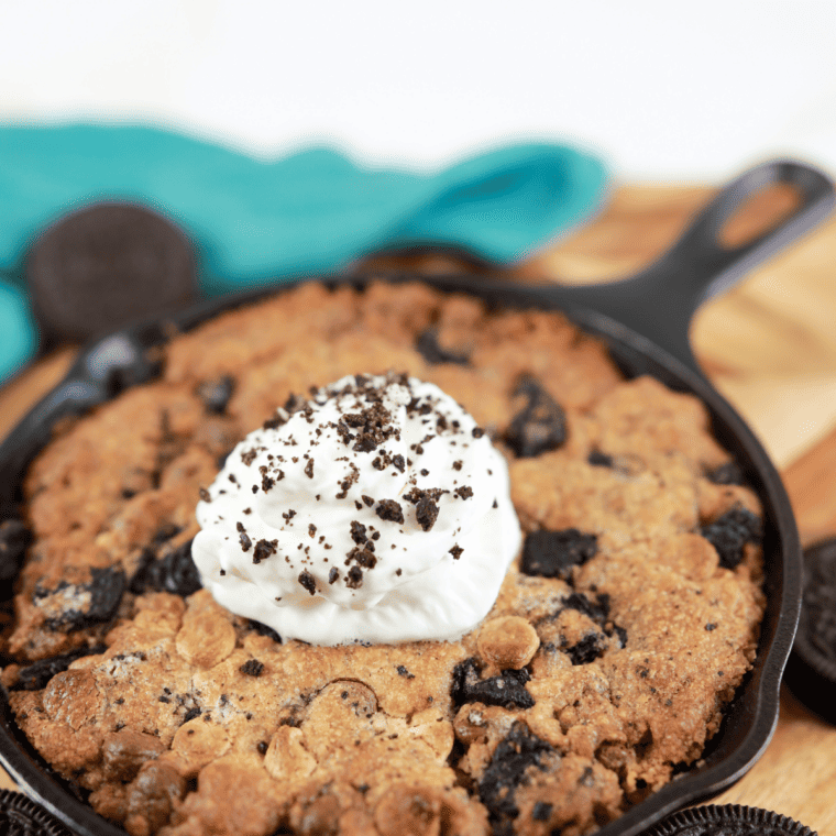 Cast-iron pan with cookie dough inside the air fryer, set to 340&deg;F for baking.