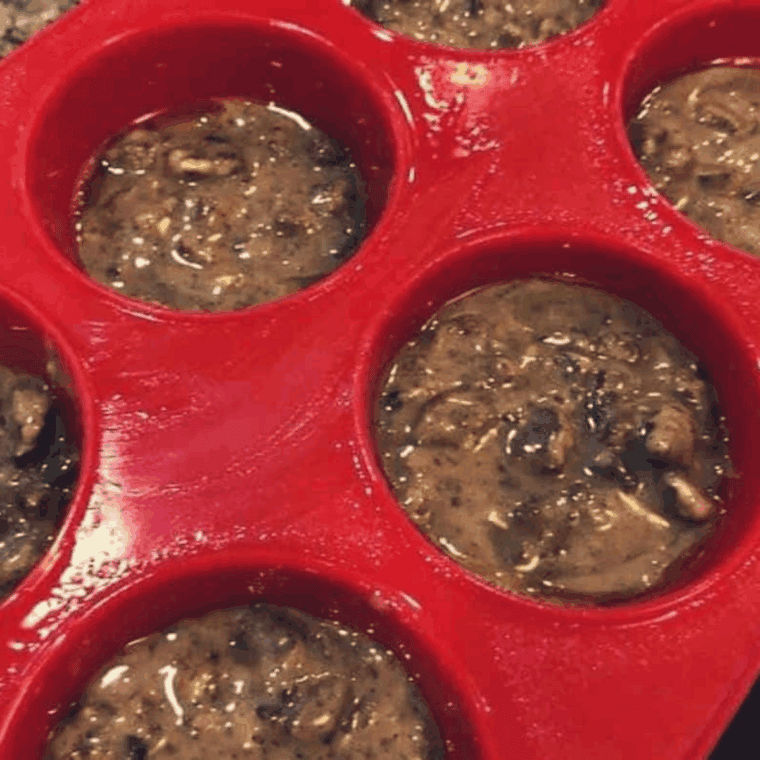 Air fryer muffin tin sprayed with cooking spray and filled three-quarters with pecan pie muffin batter