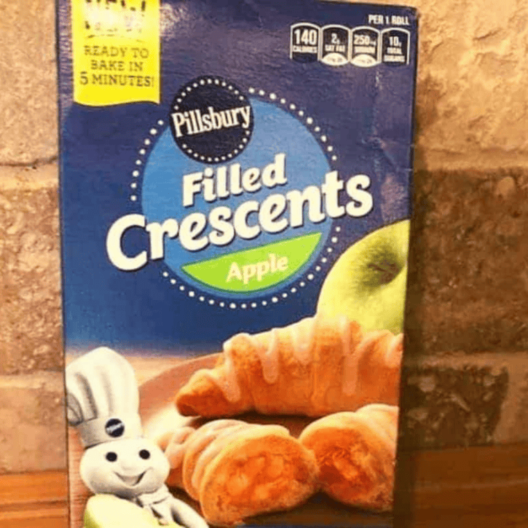 Ingredients for copycat apple filled crescents: crescent dough, diced apples, cinnamon, sugar, and icing