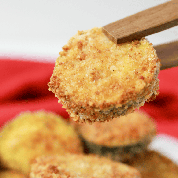Crispy air fryer zucchini sticks served on a plate with dipping sauces