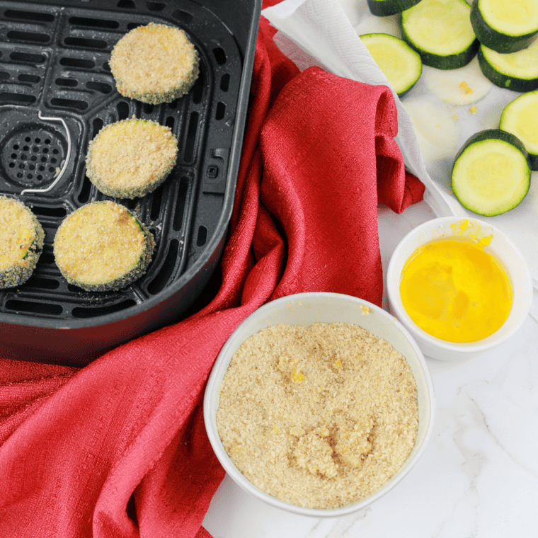 Zucchini being washed, trimmed, and sliced into uniform sticks for air frying