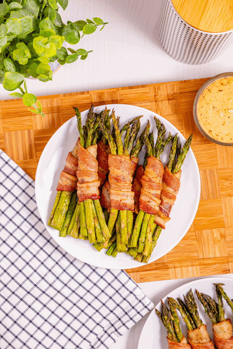 "Crispy bacon-wrapped asparagus spears cooked in an air fryer, ready to serve."