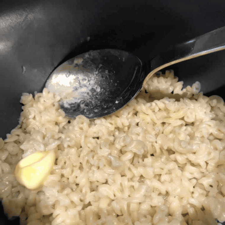 Hand flipping the Instant Pot pressure valve to venting position with steam escaping.