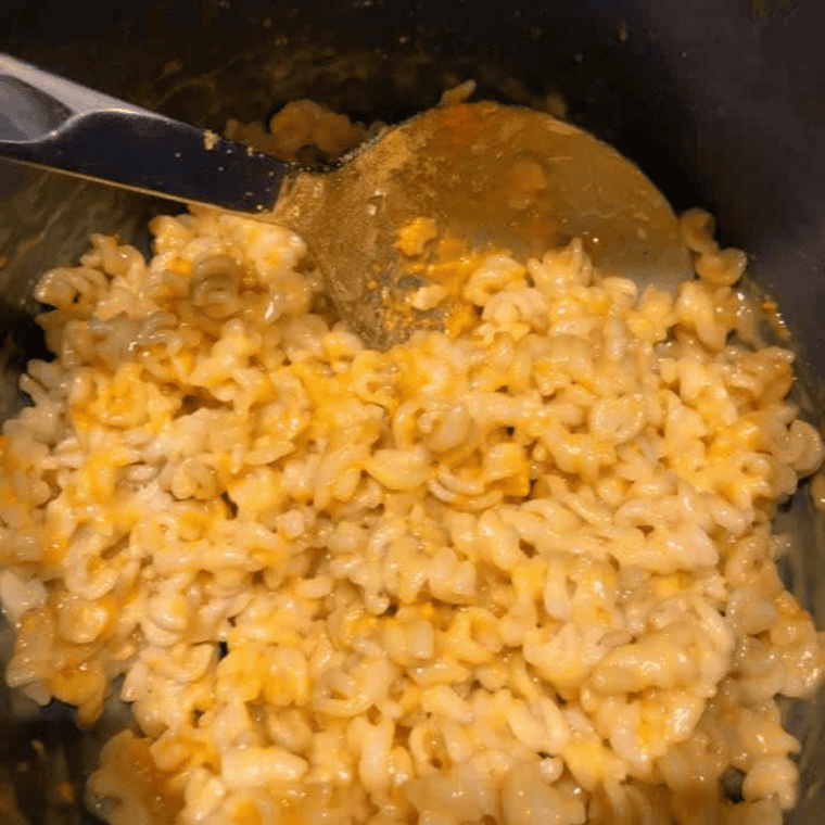 Bowl of finished creamy Instant Pot mac and cheese with a fork.