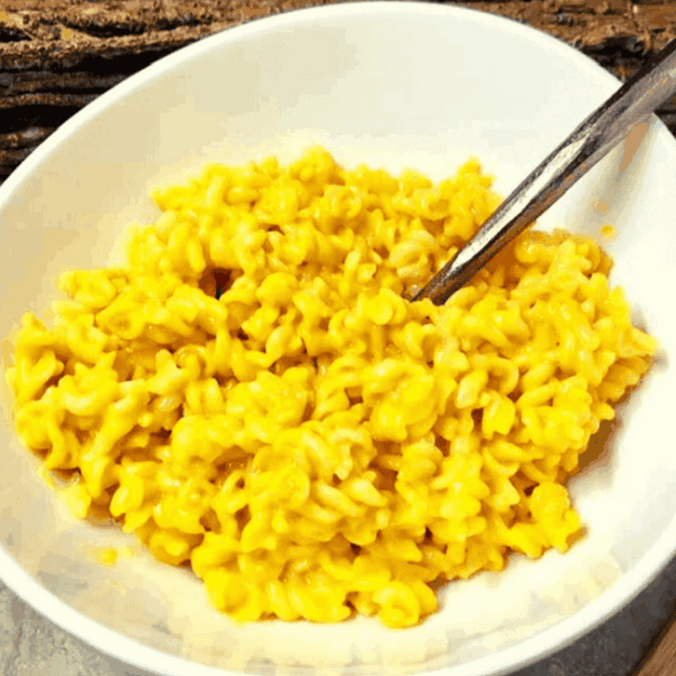Instant Pot mac and cheese with creamy cheese sauce and elbow pasta in a white bowl.