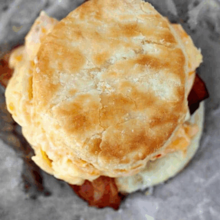 Air Fryer Breakfast Biscuits topped with eggs and crispy bacon, served warm.