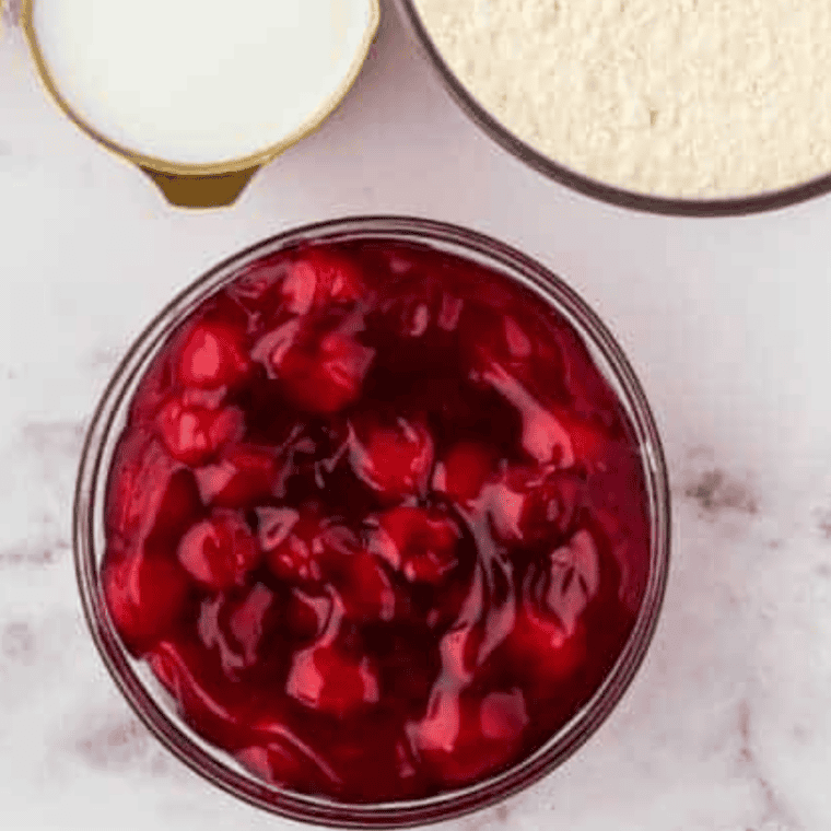 Ingredients for Air Fryer Cherry Pie Bubble Up: a can of cherry pie filling and a can of refrigerated biscuits