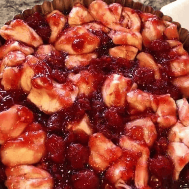  Cherry and biscuit mixture spread in an even layer in a tart pan