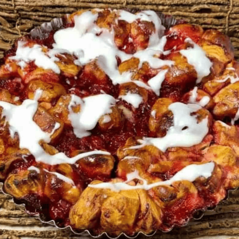 A serving of Air Fryer Cherry Pie Bubble Up topped with vanilla ice cream