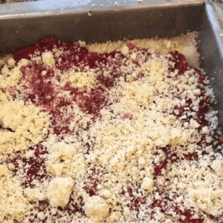 Press crumb crust into greased pan, add raspberry filling, top with remaining crumble