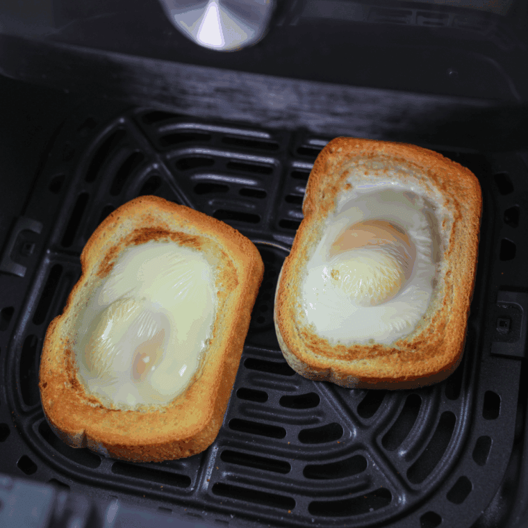 Easy Air Fryer Egg Toast with a golden, runny egg on crispy toasted bread, ready to serve.