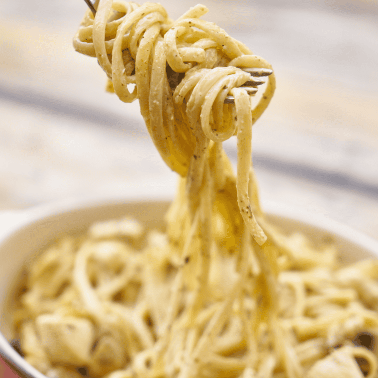 Bowl of Instant Pot Parmesan Pasta Roni Copycat with creamy cheese sauce and grated Parmesan on top