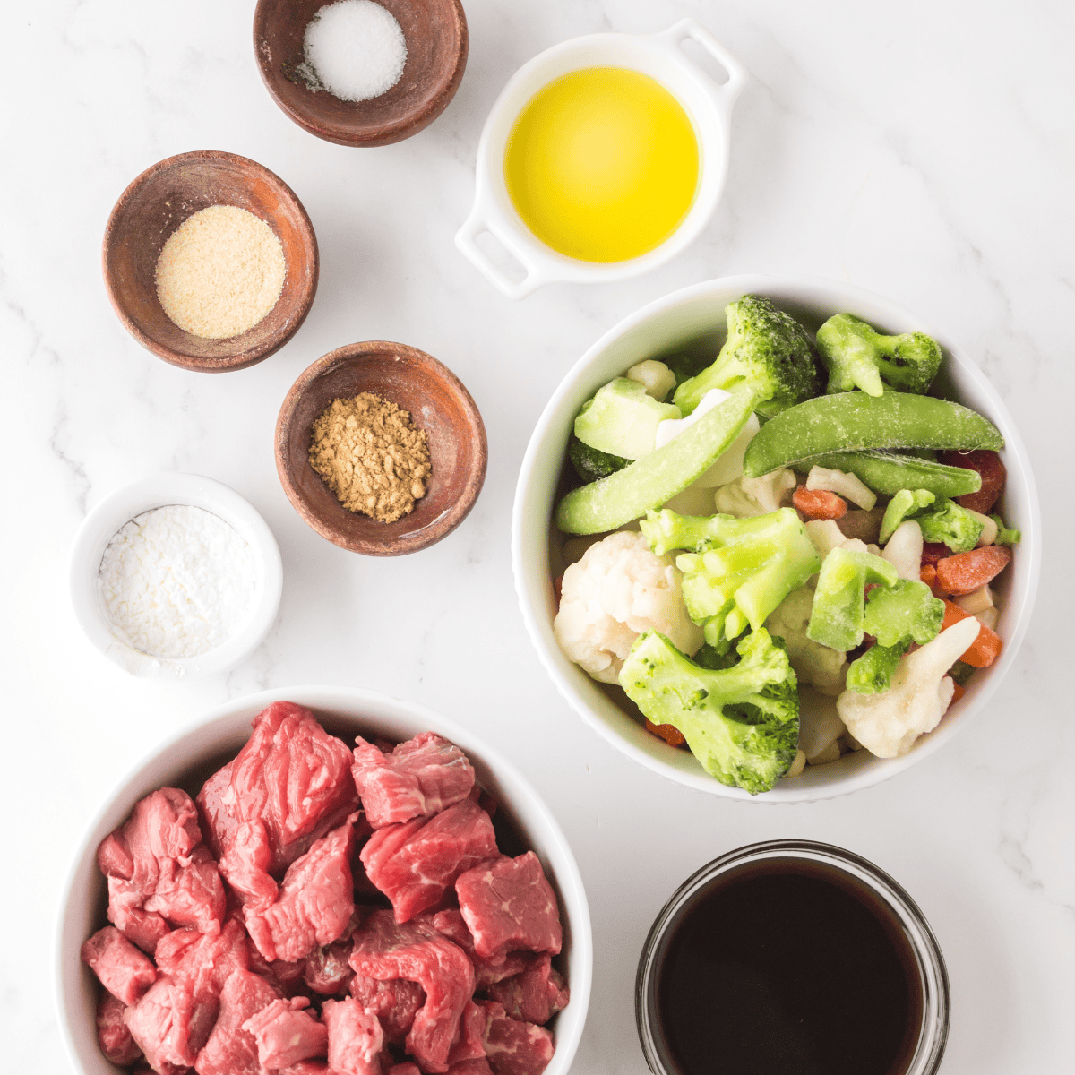 Ingredients needed for Ninja Foodi Beef Stir Fry on kitchen table.