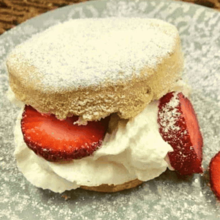 Air fryer biscuit strawberry shortcake with fresh strawberries and whipped cream.