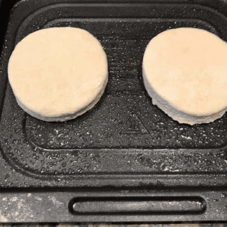 Air fryer biscuits placed on tray and cooking at 320°F.
