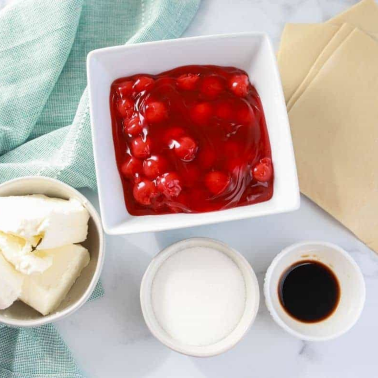 Ingredients Needed For Air Fryer Cherry Cheesecake Bites on kitchen table.