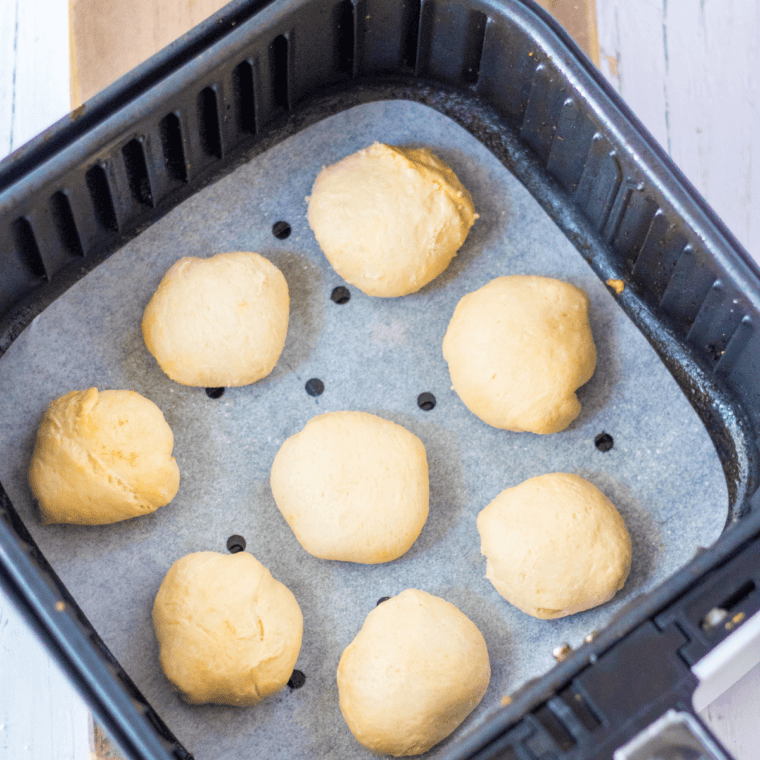 Air fryer basket set to 320&deg;F cooking churro donut holes for 3&ndash;5 minutes.